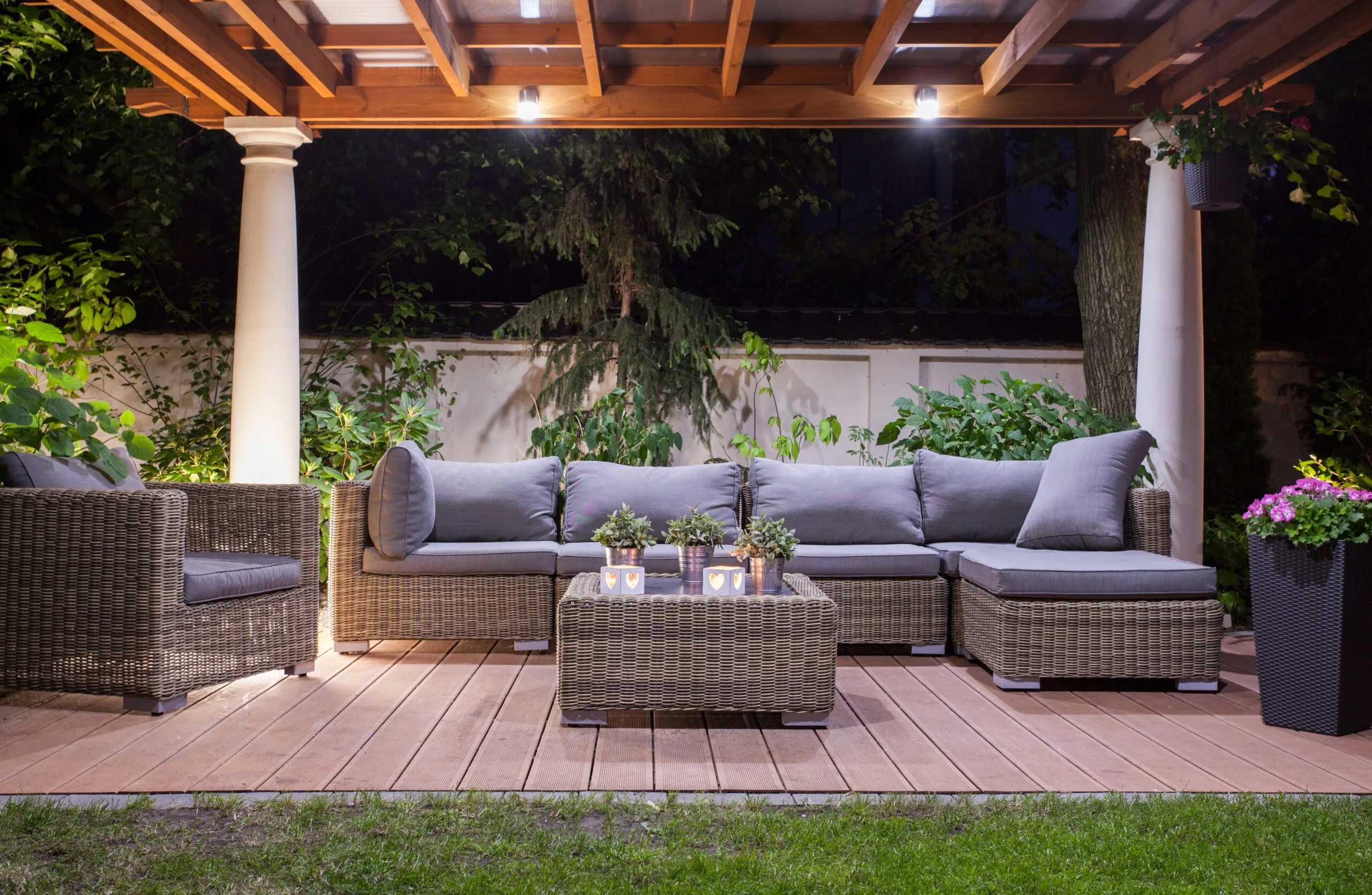 Horizontal,View,Of,Modern,Patio,At,Night Residential backyard with outdoor furniture and canopy with lights.